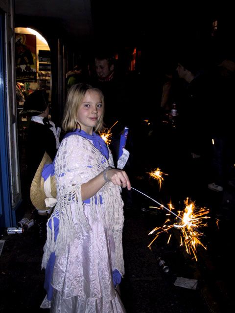 A girl in traditional dress with sparkler